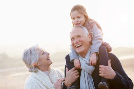 Grandma and Grandpa, with Granddaughter riding Grandpa's shoulders